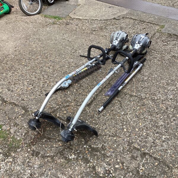 Two Titan petrol strimmers with hedge cutter attachments in a garden setting.
