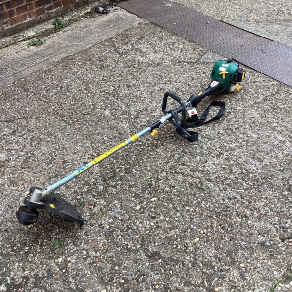 Petrol strimmer for garden maintenance and landscaping, shown in detail.