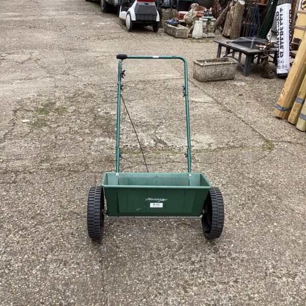 Vintage Neilsen garden seeder in a garden setting.