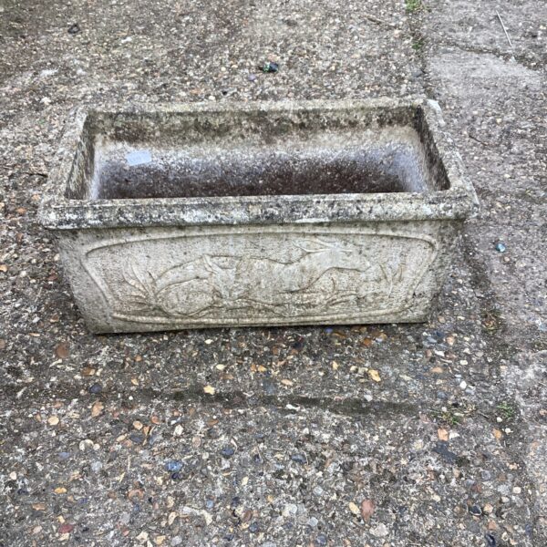 Detailed view of a stone effect garden planter with raised relief design.