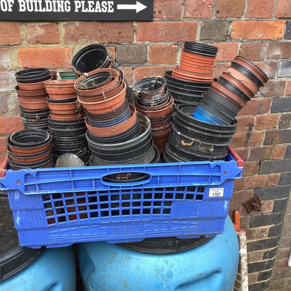 Bulk lot of terracotta coloured plastic flower pots for gardening.