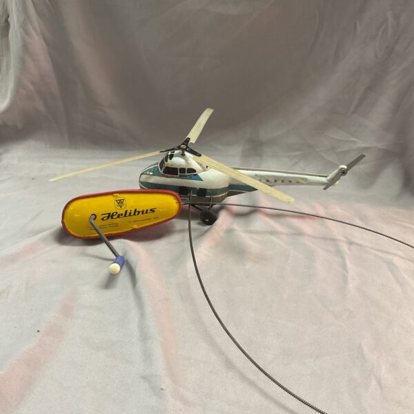 Vintage Arnold Helibus helicopter in original box, side view.