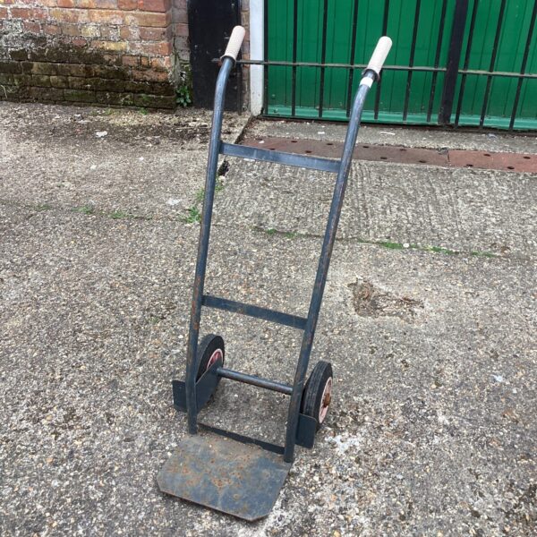 Vintage steel sack barrow with two wheels and handles.