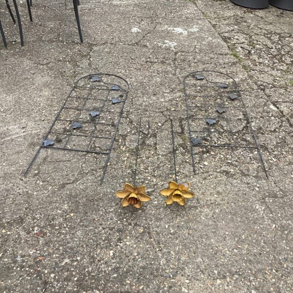 Metal garden flowers and bean climbing frames for outdoor plant support.