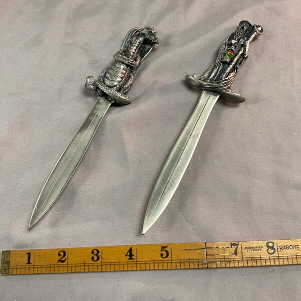 Detailed pewter paper knives featuring a wizard and dragon design.