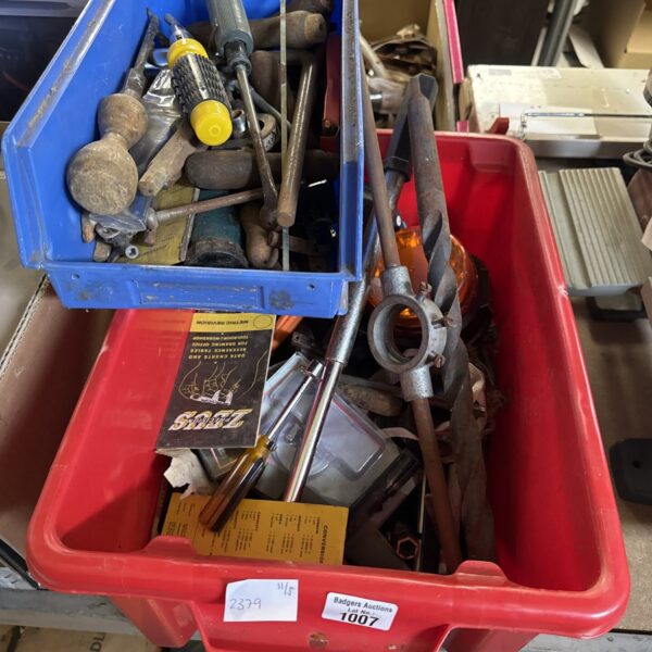 Assorted hand tools in plastic storage boxes, workshop collection.