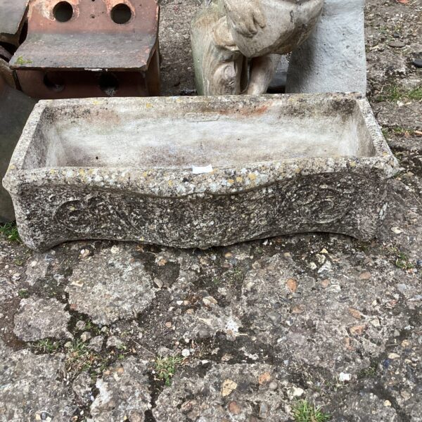 Weathered stone garden planter, ideal for outdoor plants.