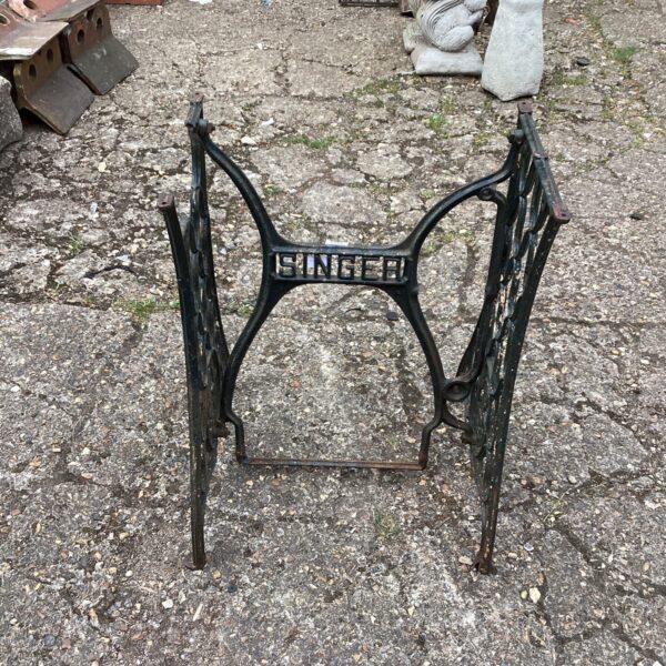 Antique Singer sewing machine base with ornate wrought iron detailing.
