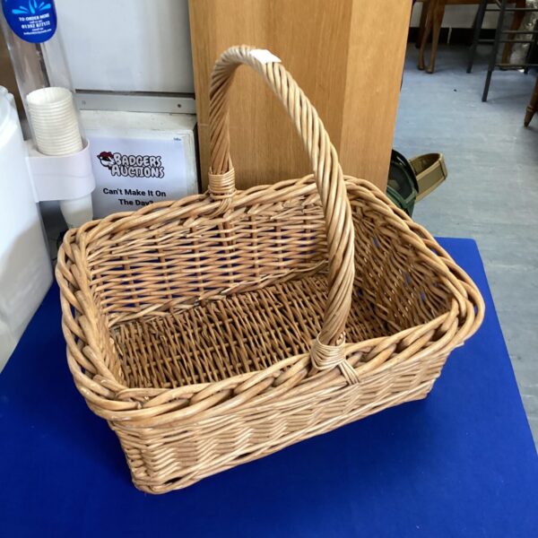 Vintage wicker basket with a chunky weave for storage.
