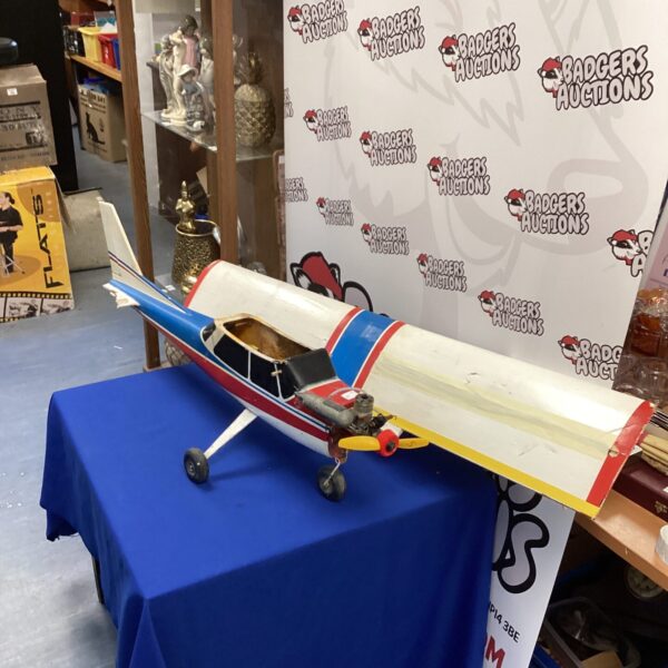 Vintage model aeroplane needing repair, classic aviation collectible.