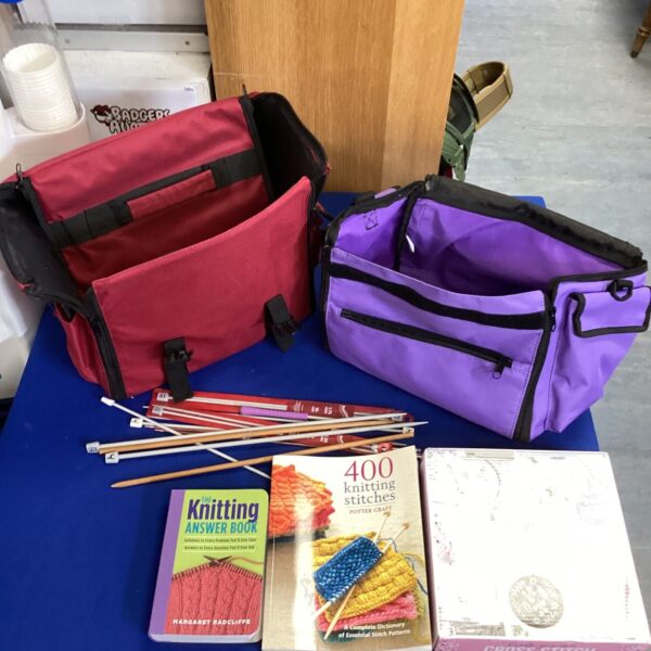 Purple craft bags with knitting supplies, a knitting craft lot.