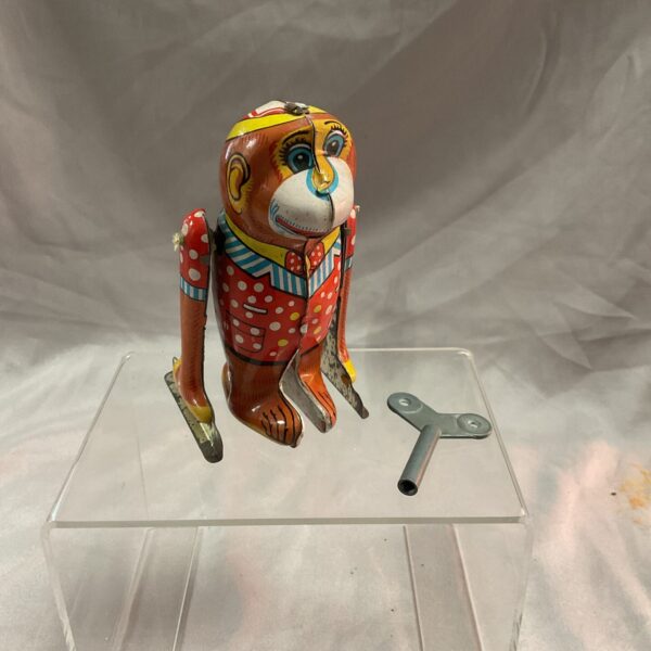 Vintage tin plate clockwork monkey, colourful and collectible.
