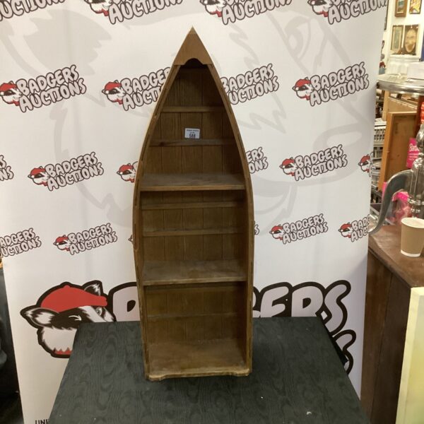 Vintage wooden wall hanging boat shelf for nautical decor.