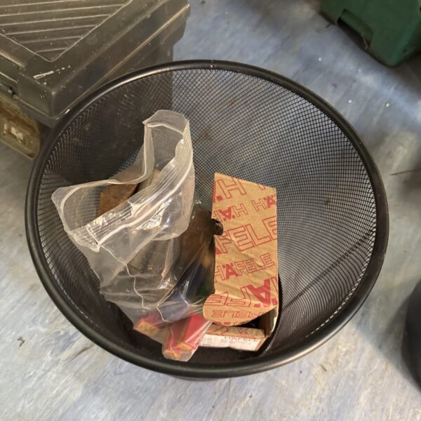 Plastic basket filled with a selection of drill and router bits.