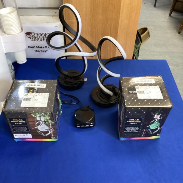 Solar wind chime lights and LED strip lights in a lot.