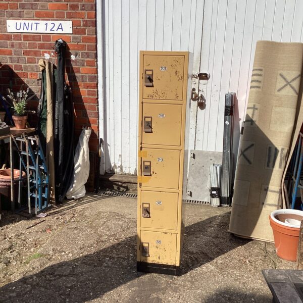 Vintage metal locker unit with multiple compartments.