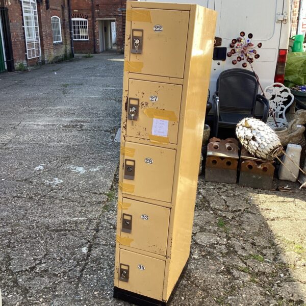 Vintage metal locker unit with key lock, ideal for storage.