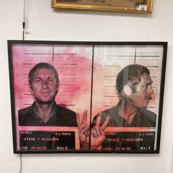 Framed Steve McQueen mugshot print, iconic celebrity memorabilia for collectors.