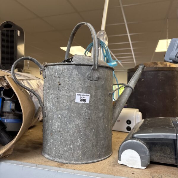 Vintage galvanised watering can with a rose head spout.