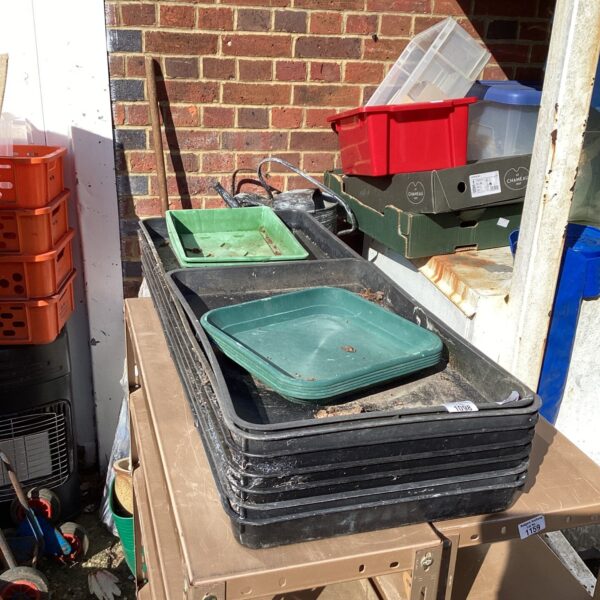Lot of used plastic greenhouse trays for gardening.