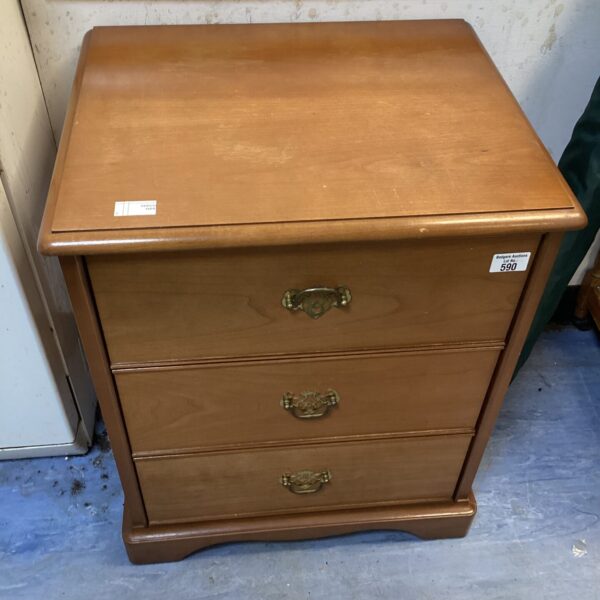 Vintage three-drawer bedside cabinet in warm wood tone.