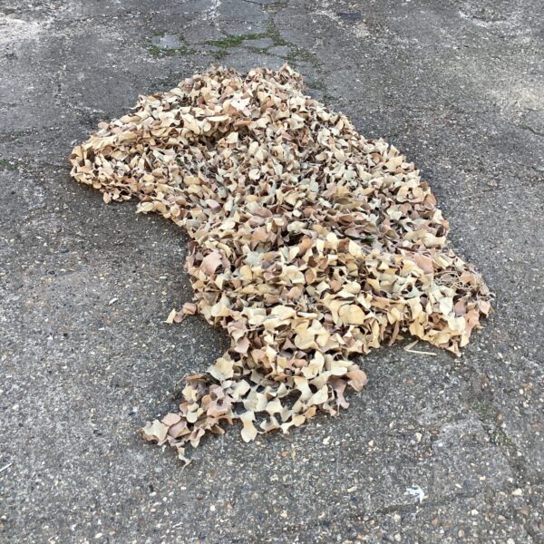 Large lot of used camouflage netting for outdoor use.