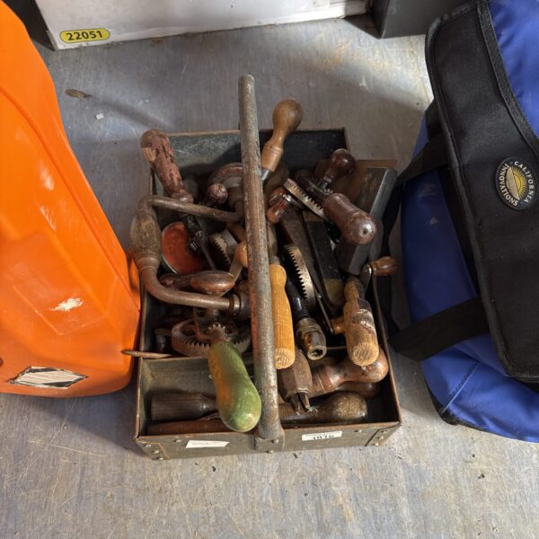 Selection of vintage hand drills with wooden handles.