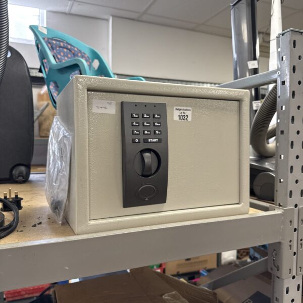 Steel personal safe with keyed lock for securing valuables.