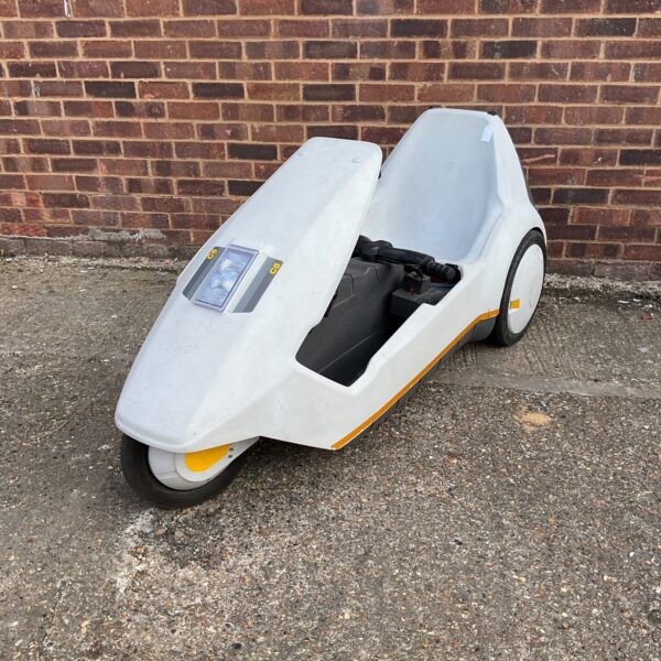Side view of a vintage Sinclair C5 electric vehicle.