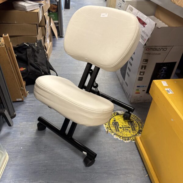 Black ergonomic kneeling chair with padded seat and foldable frame.