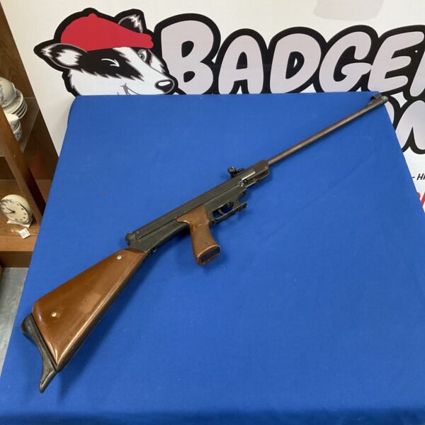 Vintage Asi Paratrooper .22 caliber air rifle with wooden stock.