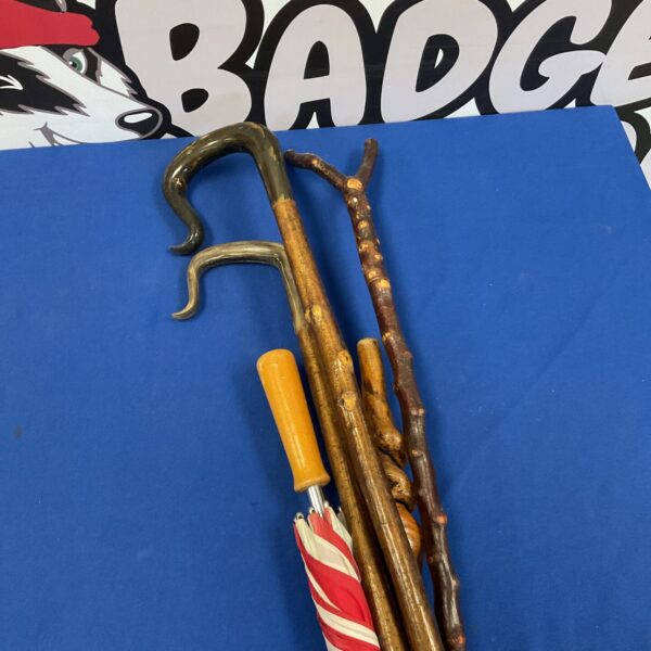 Bundle of antique walking sticks and shepherd crooks for collectors.