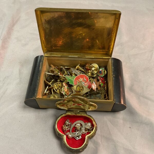 Vintage jewellery lot displayed in metal boxes.