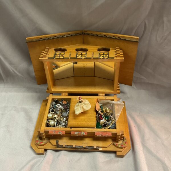 Vintage Swiss chalet jewellery box with open lid and jewellery.