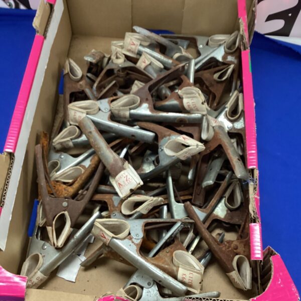 Quantity lot of metal sheet clips for workshop use.