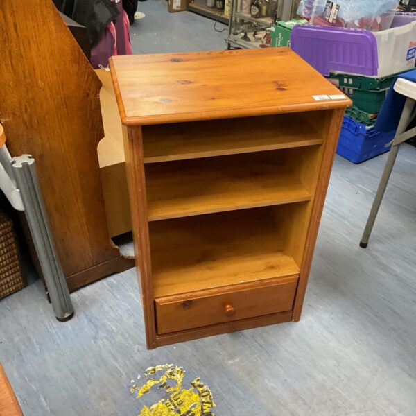 Small pine two-drawer cabinet with wooden construction for storage.
