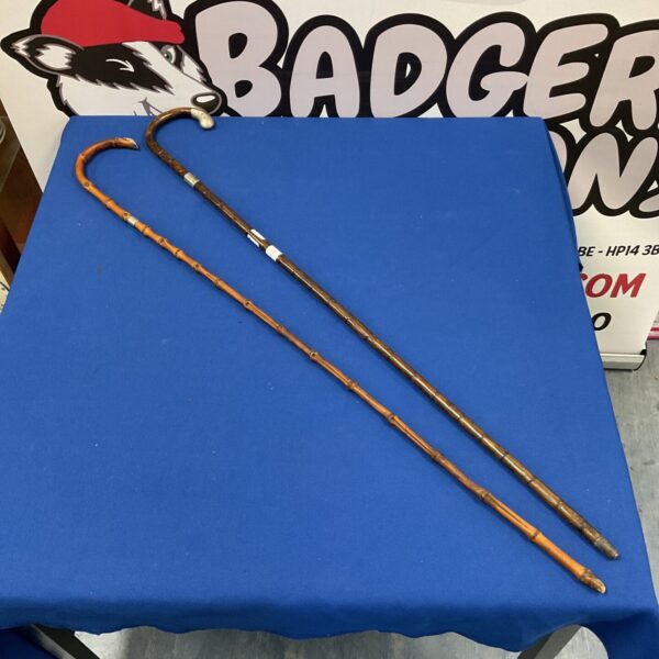 Two vintage walking canes with sterling silver details.
