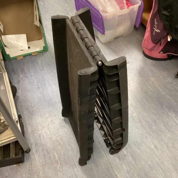 Black plastic folding pet ramp for animal access.