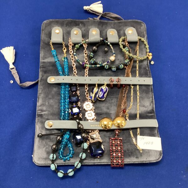 Vintage jewellery roll with colourful beaded necklaces and costume jewellery.
