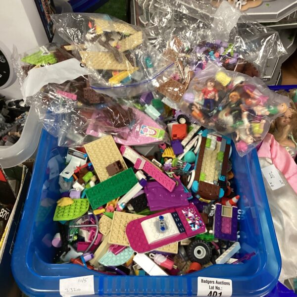 Mixed Lego and Playmobil lot with colourful building blocks and figures.