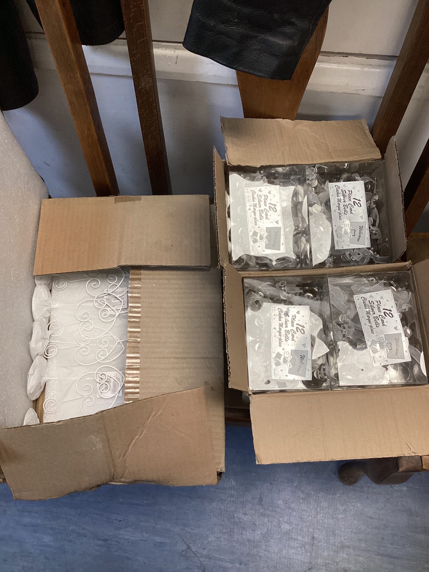 529 Three boxes of silver bell place card holders with stands