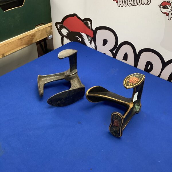 Antique wrought iron shoe lasts, vintage footwear molds for display.