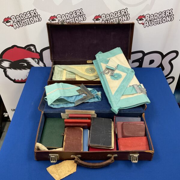 Vintage leather Masonic cases and colourful sashes displayed open.