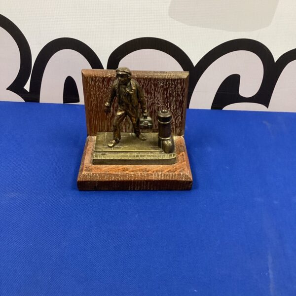 Vintage bronze figurine of a working man on stone base.