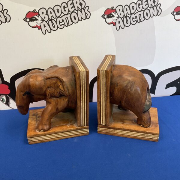 Vintage carved wooden elephant bookends for home decor.