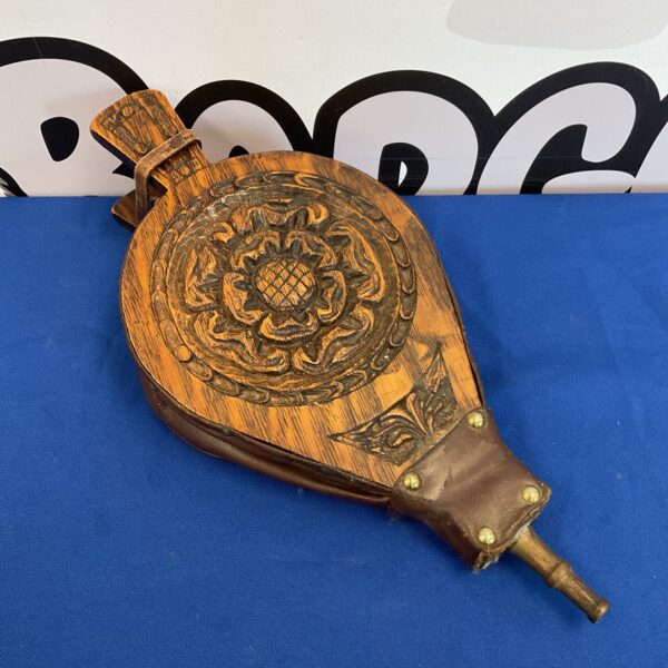 Antique carved oak fireplace bellows with English rose detail.