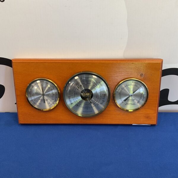 Vintage Weathermaster barometer, thermometer, and hygrometer in wood.
