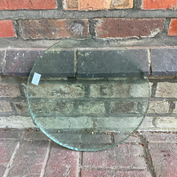 Round glass porthole window with a vintage aesthetic.