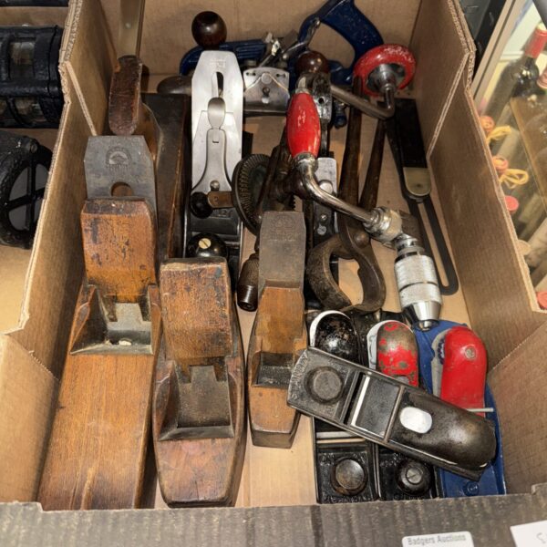 Vintage collection of hand planes and woodworking tools.