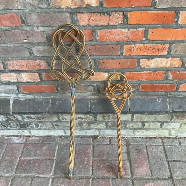 Vintage carpet beater pair for cleaning and antique display.